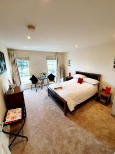 a bedroom with a bed and a table and chairs at Beach View Ballycastle Escape in Ballycastle