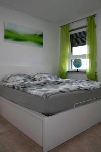 a bed sitting in a room with a window at Design Apartment Harz-Relax in Harzgerode