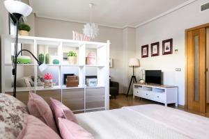 a bedroom with a bed and a tv in it at Apartamento Málaga Litoral Beach in Málaga