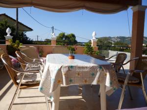 a table with chairs and a table cloth on a patio at Kostas Apartments & studios in Agios Georgios Pagon