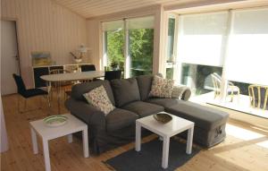 a living room with a couch and a table at Stunning Home In Rnne With Kitchen in Rønne