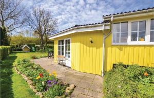 a yellow house with a garden in front of it at Two-Bedroom Holiday Home In Broager in Broager +10 photos