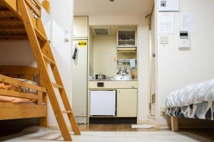a room with a kitchen and a bunk bed at Cocone house Ohoripark in Fukuoka