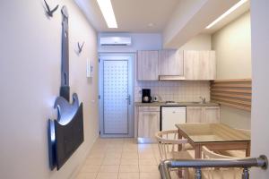 a kitchen with a table and a dining room at Blue Sky Hotel Apartments in Rethymno