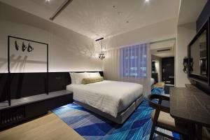Voodi või voodid majutusasutuse Osaka Excel Hotel Tokyu toas