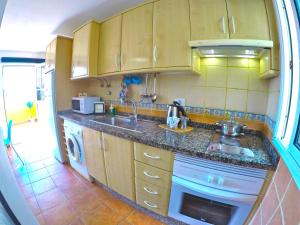 a small kitchen with a sink and a stove at Apartamentos Ester in Santa Cruz de Tenerife