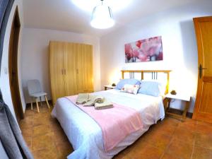 a bedroom with a large bed with towels on it at Apartamentos Ester in Santa Cruz de Tenerife