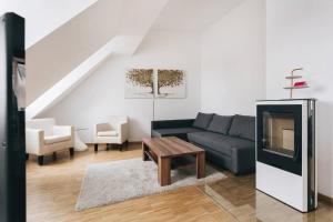 a living room with a couch and a table at Dill Apartment Frauenkirchenblick Dresden in Dresden