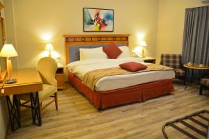 a hotel room with a bed and a desk at The Y Hotel in Amman