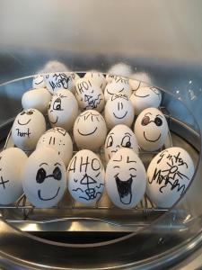 Um monte de ovos com caras desenhadas neles. em Der LeuchtTurm-Gastro GmbH em Geierswalde