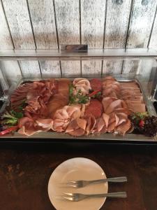 a tray filled with meat and meats on a table at Der LeuchtTurm-Gastro GmbH in Geierswalde