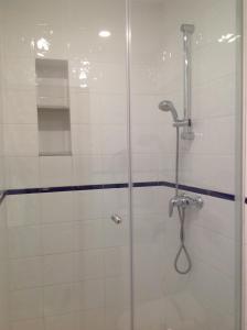 a bathroom with a shower with a glass door at Vehí in Cadaqués