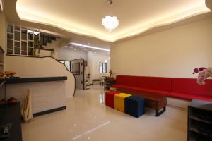 a living room with a red couch and a table at Sweet Dream Homestay in Magong