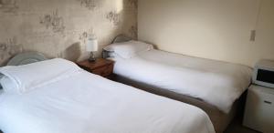 A bed or beds in a room at Beoley Lodge 