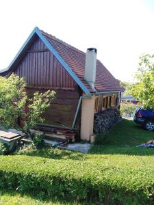 a small house with a yard in front of it at Jana in Bukovac