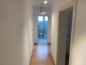 an empty hallway with a toilet in a bathroom at Apartment First Floor Laatzen in Hannover