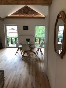 a dining room with a table and chairs and a mirror at Villa Nussbaum in Golling an der Salzach