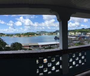 a view out of a window of the water at Harbour Vista Inn in Castries