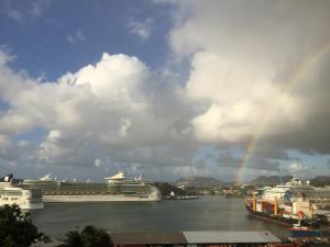 a rainbow over two cruise ships in the water at Harbour Vista Inn in Castries