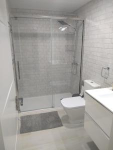 a bathroom with a shower and a toilet and a sink at Villa maravillosa in San Bartolomé de Tirajana +20 photos