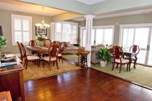 a dining room and living room with a table and chairs at DeSoto Beach Bed and Breakfast in Tybee Island