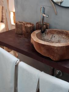 a wooden sink on a table in a bathroom at Cactus Host in Las Palmas de Gran Canaria