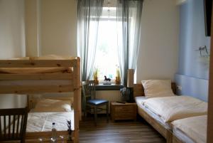 1 dormitorio con 2 literas y ventana en Romagna Mia - Hotel Ristorante Pizzeria, en Nersingen