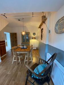 a dining room with a table and chairs at The Stopping Point Stylish Coastal Retreat near Cartmel & Lake District in Flookburgh
