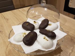 a glass bowl of donuts on a table at Holiday House da Carlo in Catania