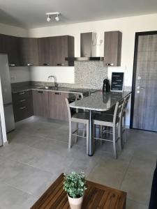 a kitchen with a table and chairs in a room at clos des oliviers in Cargèse