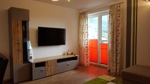 a living room with a flat screen tv on a wall at 4 Jahreszeiten in Tamsweg