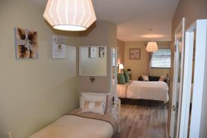 a bedroom with two beds and a chandelier at Shalom in Carlingford