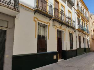 a row of buildings with balconies on a street at Ático en el Corazón de Sevilla in Seville