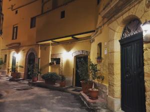 un callejón con macetas al lado de un edificio en Alloggio della Posta Vecchia, en Agrigento
