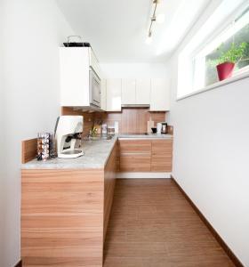 a kitchen with white cabinets and a counter top at Ferienwohnung Wohlfühlen in Pfunds