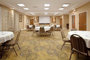 a conference room with tables and chairs and a whiteboard at Holiday Inn Express Pembroke by IHG in Pembroke +67 photos