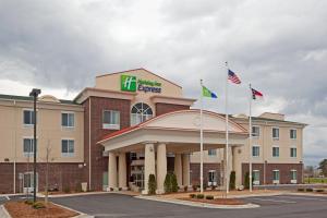 un hotel con dos banderas frente a un edificio en Holiday Inn Express Pembroke, an IHG Hotel, en Pembroke