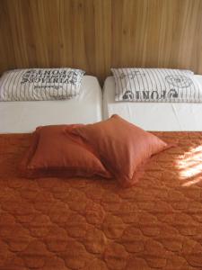 two beds with pillows sitting on top of a bed at Private Rooms Silvia in Varna City