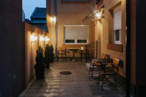 a patio with a table and chairs in a building at Matino Apartments 3 in Valjevo
