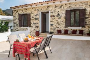 a patio with a table and chairs and a building at Fairytale Elafonisi in Perivólia