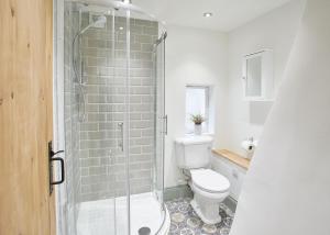 a bathroom with a toilet and a glass shower at Host & Stay - Threadneedle Cottage in Whitby