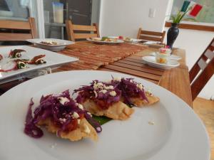 a table with plates of food on top at Hotel Rockaway in Puerto Escondido