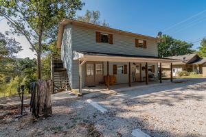a house that is sitting on top of a street at Cottages at Fair Haven Cove in Cape Fair +14 photos