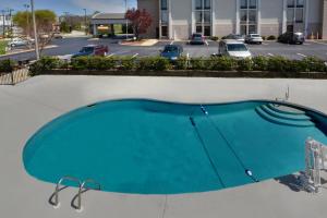 a blue swimming pool on a building with a parking lot at Holiday Inn Express Lynchburg, an IHG Hotel in Lynchburg