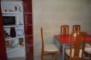 a dining room with a red table and chairs at MARIELI in Barakaldo