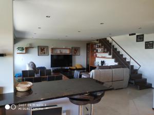 sala de estar con mesa y escalera en Apartamento Mariano Cabedelo, en Viana do Castelo