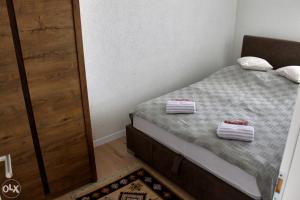 a bedroom with a bed with two towels on it at Stan na dan 2, Sarajevo in Sarajevo