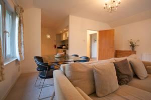 a living room with a couch and a table at Loch Ness Abbey Cottages in Fort Augustus