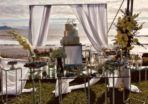 a table set up for a wedding on the beach at La Mansión Residency Suites Ensenada in Ensenada