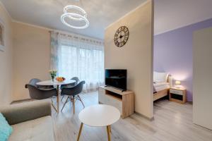 a living room with a couch and a table at Fancy Apartments Old Town in Gdańsk